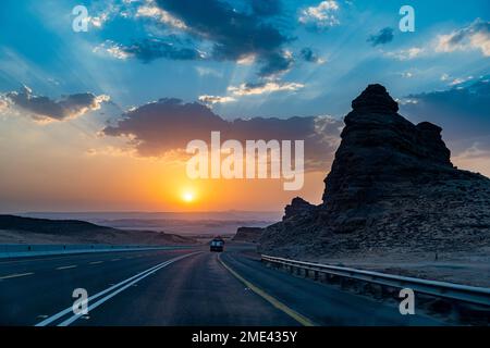 Saudi Arabia, Al-Ula, Sun setting over remote highway Stock Photo