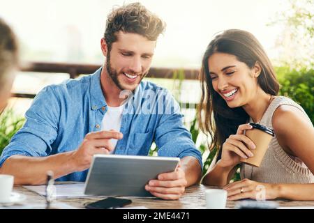 Ive got to show you this new app. two businesspeople using a digital tablet together outdoors. Stock Photo