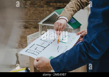 Hands of architects discussing over blueprint at construction site Stock Photo