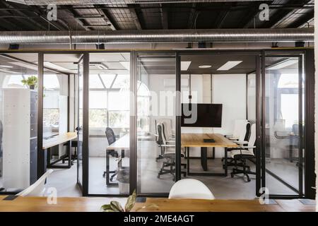 Empty coworking office with conference tables and chairs Stock Photo