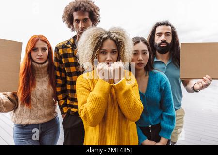 Confident protestors with placard standing with each other Stock Photo