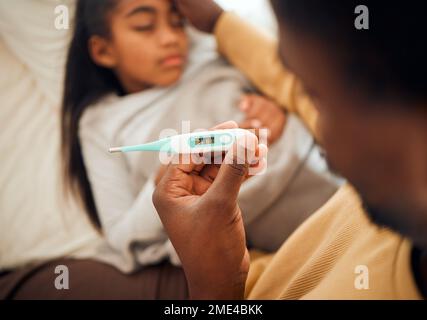 Child, girl and dad checking thermometer for ill kid or daughter lying on a bed feeling sad. Support, care and parent in bedroom to help a worried Stock Photo