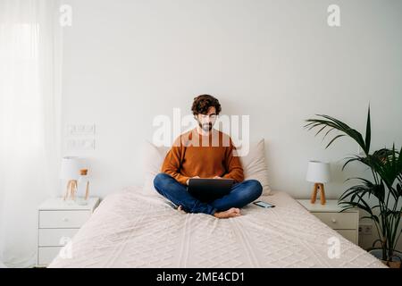 Young freelancer working on laptop at home Stock Photo
