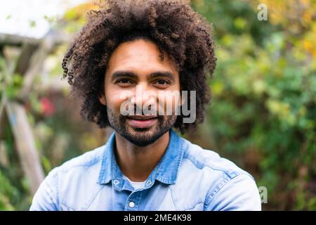 Smiling man with afro hairstyle and beard Stock Photo