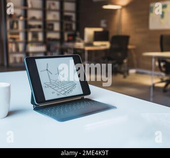 Tablet PC with design of solar panels and wind turbines Stock Photo