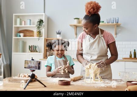 Happy Smiling African Family In Aprons Cooking And Kneading Dough On Wooden  Table Stock Photo - Download Image Now - iStock