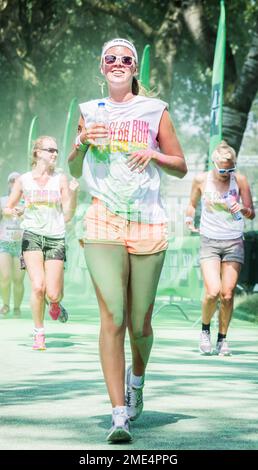 ZWOLLE, THE NETHERLANDS - AUGUSTUS 2 2014: Three women passing the Marsweg checkpoint during the Color Run. Stock Photo