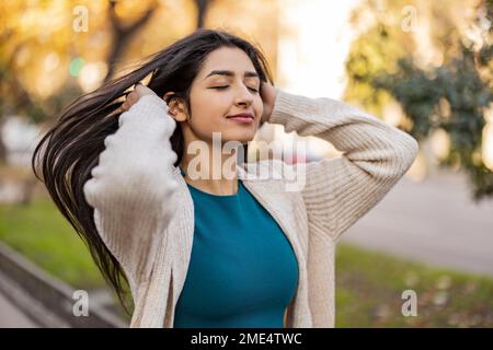 Happy woman with eyes closed standing at park Stock Photo