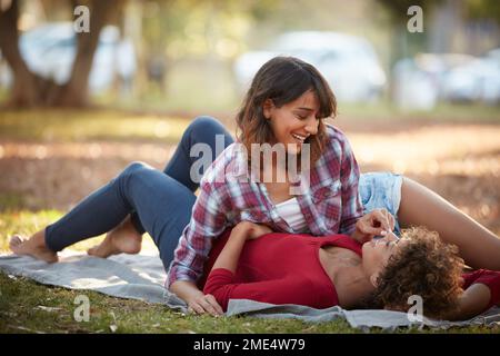 I think youre amazing. a young couple spending the day outdoors on a sunny day. Stock Photo