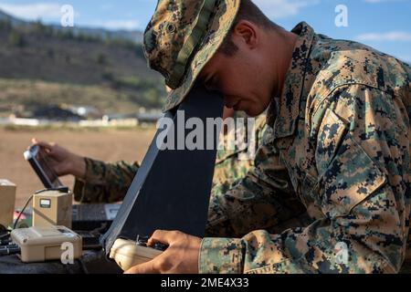 Cpl. Cole Millard, a Raven-B RQ-11 operator and intelligence specialist with H&S Company, 1st Battalion, 24th Marine Regiment, 4th Marine Division, Marine Forces Reserve, observes a Raven-B RQ-11 drone in flight through a Raven-B RQ-11 controller device at Marine Corps Mountain Warfare Training Center, Bridgeport, Calif., July 27, 2022, for Mountain Training Exercise 4-22. MTX 4-22 prepares Marines for the challenges of operating in a harsh, mountainous environment many of their adversaries are acclimated to. #MFRMTX22,1/24,MARFORRES,MTX,MWTC, Stock Photo