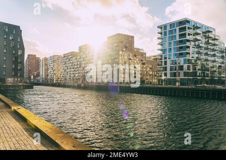 Denmark, Aarhus, Sun setting over modern apartments in Aarhus Docklands Stock Photo