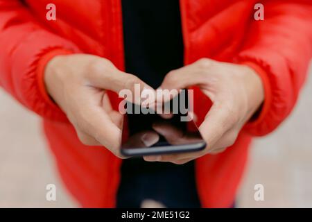 Hands of man using smart phone Stock Photo