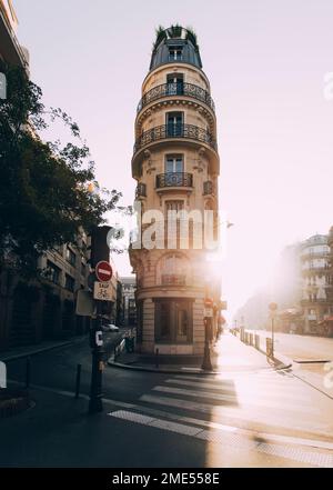 France, Ile-de-France, Paris, Zebra crossing in front of narrow apartment building at sunrise Stock Photo