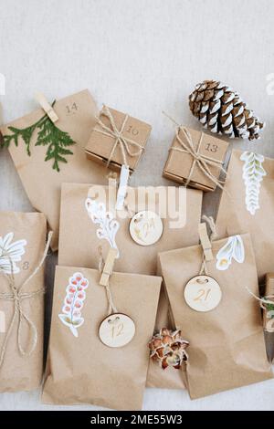 Decorated paper bags kept with pine cones on carpet Stock Photo