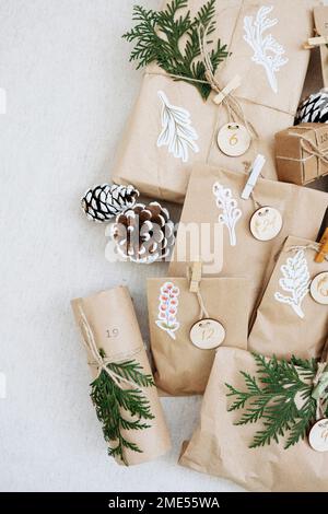 Decorated brown paper bags kept with pine cones on carpet Stock Photo