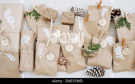 Decorated paper bags with pine cones and cardboard boxes on carpet Stock Photo