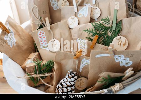 Decorated brown bags with gift boxes and pine cones kept in basket Stock Photo