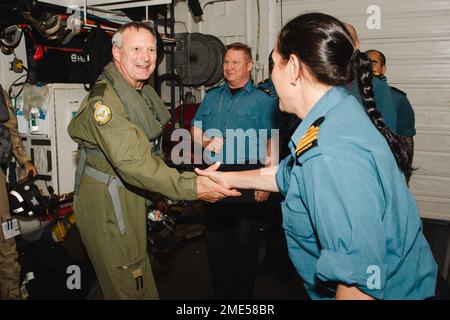 VIRIN # PACIFIC OCEAN (July 27, 2022) - Royal Canadian Air Force Joint Force Air Component Commander Brigadier-General Goulden is greeted by Commander Annick Fortin, Commanding Officer of the Royal Canadian Navy frigate HMCS Winnipeg (FFH 338) during Rim of the Pacific (RIMPAC) 2022, July 27. Twenty-six nations, 38 ships, three submarines, more than 170 aircraft and 25,000 personnel are participating in RIMPAC from June 29 to Aug. 4 in and around the Hawaiian Islands and Southern California. The world’s largest international maritime exercise, RIMPAC provides a unique training opportunity whil Stock Photo