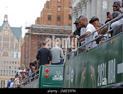 Milwaukee Bucks' P.J. Tucker spits out champagne as he holds the NBA  Championship trophy during a parade celebrating the Milwaukee Bucks' NBA  Championship basketball team Thursday, July 22, 2021, in Milwaukee. (AP