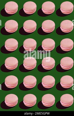 seamless pattern of pink macaroon cookies on green background  Stock Photo