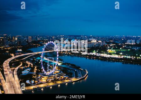 City lights in Southeast Asia from above river flowing to ocean Stock Photo