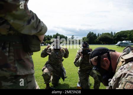 Members of the 374th Civil Engineer Squadron and the 138th Civil Engineer Squadron from Tulsa Air National Guard Base, Oklahoma, equip and check their gas masks during a chemical, biological, radioactive and nuclear site survey training at the Sagami General Depot, Japan. This training allows ANG members to integrate with an active-duty component and practice agile combat employment techniques. Stock Photo