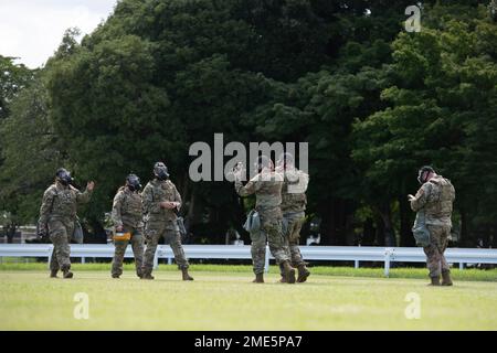 Members of the 374th Civil Engineer Squadron and 138th Civil Engineer Squadron from Tulsa Air National Guard Base, Oklahoma, rendezvous after perform a sweep of the area during a chemical, biological, radioactive and nuclear site survey training at the Sagami General Depot, Japan. This training allowed for the ANG to integrate with overseas active-duty members similar to what could be expected during a real-world deployment. Stock Photo