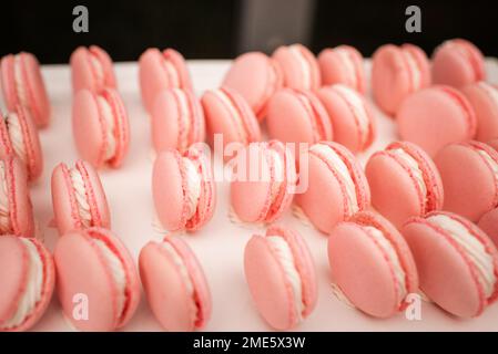 Side Angle View of Pink Macaroons On Table Stock Photo