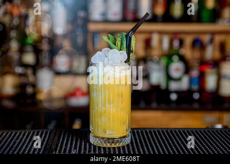 glass of pineapple cocktail served on a bar counter Stock Photo