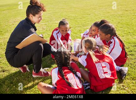 Huddle, sport or coach with children hands for soccer strategy training or team goals in Canada. Team building, circle or woman and group of girls on Stock Photo