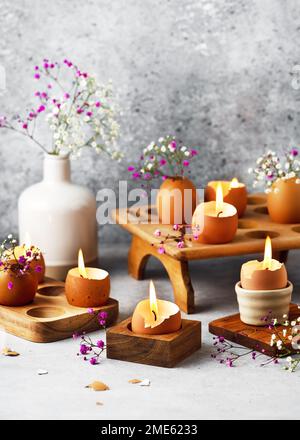Beautiful handmade candles made from eggshells and wax. Easy handmade home decoration. Hobby and DIY concept. Copy space. Stock Photo