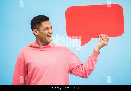 Happy man, laughing or speech bubble on isolated blue background for social media, vote mock up or idea mockup. Smile, student or model with Stock Photo