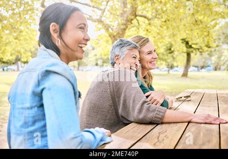 Park, senior women and friends laughing at funny joke, crazy meme or comedy. Comic, happy and group of retired females sitting at table with humor Stock Photo