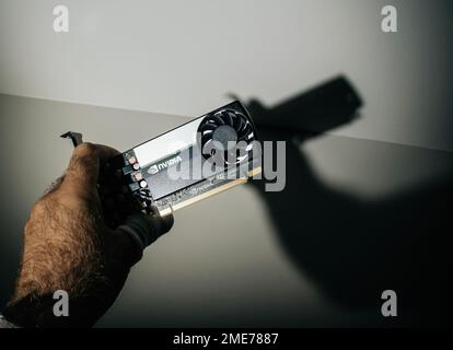 Santa Clara, United States - Jul 14, 2022: POV IT engineer holding in dark server room new NVIDIA T600 video card with NVIDIA Turing GPU cores enabling professionals to tackle multi-app workflows Stock Photo