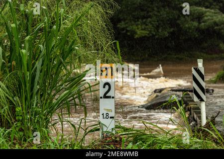 Depth marker showing level of South Pine River flooding at Bunya Road crossing in March 2021 on the outskirts of Brisbane, Australia Stock Photo