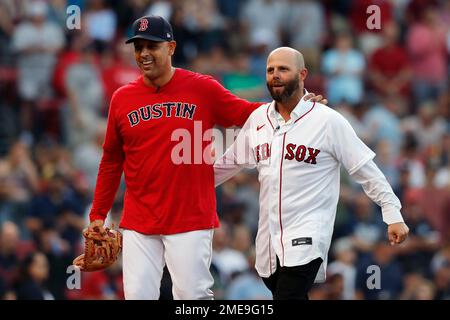 Former Boston Red Sox's Dustin Pedroia, right, walks off the field with his  family and former player Pedro Martinez, left, after ceremonies in  Pedroia's honor before a baseball game against the New