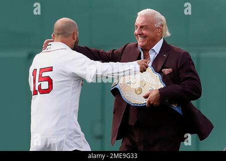 Former Boston Red Sox's Dustin Pedroia, right, walks off the field with his  family and former player Pedro Martinez, left, after ceremonies in Pedroia's  honor before a baseball game against the New