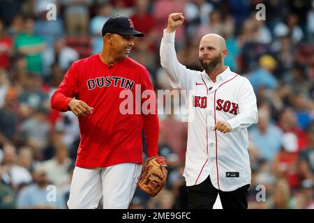 Former Boston Red Sox's Dustin Pedroia, right, walks off the field with his  family and former player Pedro Martinez, left, after ceremonies in Pedroia's  honor before a baseball game against the New