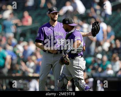 Colorado Rockies relief pitcher Daniel Bard left fielder Connor Joe (9) and  catcher Elias Diaz at the end of a baseball game against the Chicago Cubs  in Chicago, Sunday, Sept. 18, 2022. (