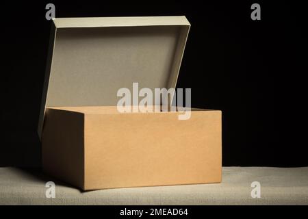 Open cardboard box on black background, copy space Stock Photo