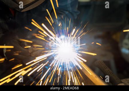 Using semiautomatic argon gas shielded welding semi-automatic machine worker works welding metal Stock Photo
