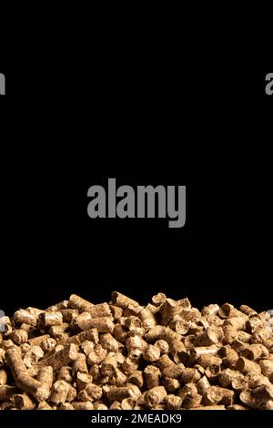 Heap of cat litter pellets on black background Stock Photo