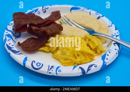 Plate with scrambled egg and bacon on white background Stock Photo - Alamy