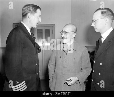 Capt. Beverly M. Coleman, left, of Wash., D.C., and Lieut. Valentine B. Deale, right, of Cleveland, both of the American defense staff at the War Crimes Trials in Tokyo, chat with former Japanese Prime Minister and military leader Hideki Tojo, on trial for war crimes, as they discuss the defense at the opening of the trials, on May 3, 1946. The declassified U.S. military documents show the ashes of seven executed war criminals, including wartime Prime Minister Tojo, were scattered at sea off Yokohama from a U.S. army plane. (AP Photo/Charles Gorry)