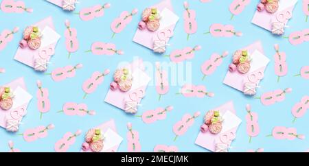 Envelopes, paper figures 8 and flowers on light blue background. Pattern for International Women's Day Stock Photo