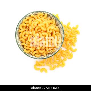 Bowl of raw elbow pasta on white background Stock Photo