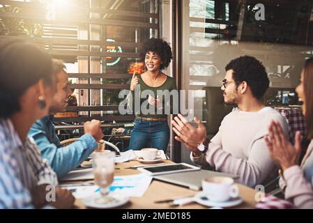 Im glad that everyone agrees with the concept. a cheerful young group of work colleagues clapping hands after a presentation by one of their Stock Photo
