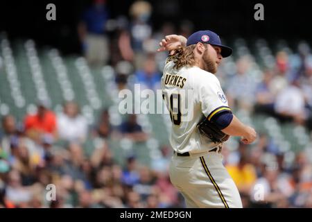 Milwaukee Brewers' Corbin Burnes adjusts his hair during the sixth inning  of a baseball game against the San Francisco Giants Friday, Aug. 6, 2021,  in Milwaukee. (AP Photo/Aaron Gash Stock Photo - Alamy