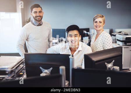Were always productive. Cropped portrait of three creative colleagues working together in the office. Stock Photo