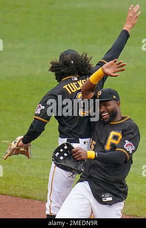 Colorado Rockies' Cole Tucker (3) celebrates with third base coach/infield  coach Warren Schaeffer (34) after hitting a solo home run during the third  inning of a spring training baseball game against the